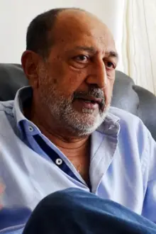Tinnu Anand como: Foster Father with Crooked Teeth