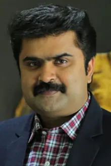 Anoop Menon como: Dr. John Mathai